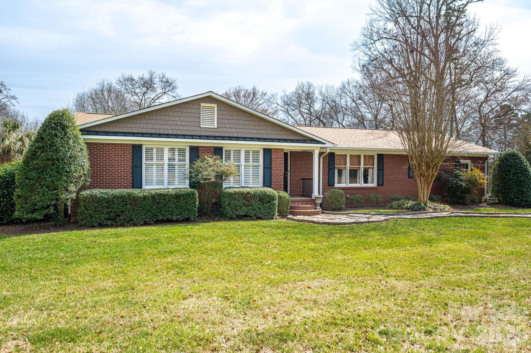 872 Armstrong Road Belmont, NC 28012 - Photo 3 of 48 a front view of a house with yard and green space