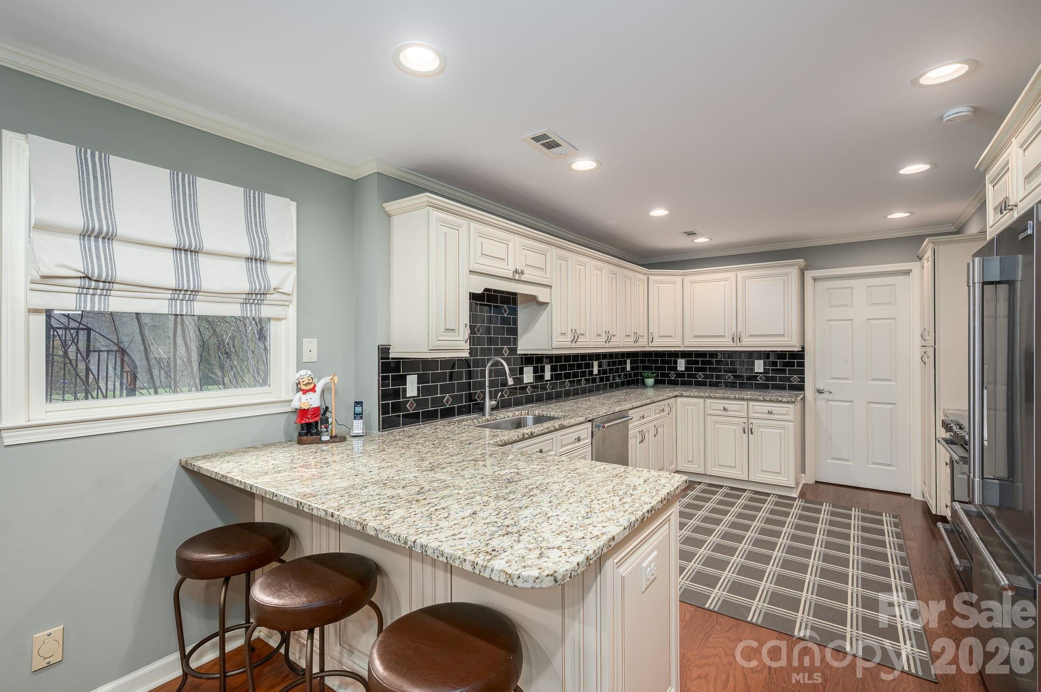 872 Armstrong Road Belmont, NC 28012 - Photo 43 of 48 a kitchen with a sink refrigerator and cabinets
