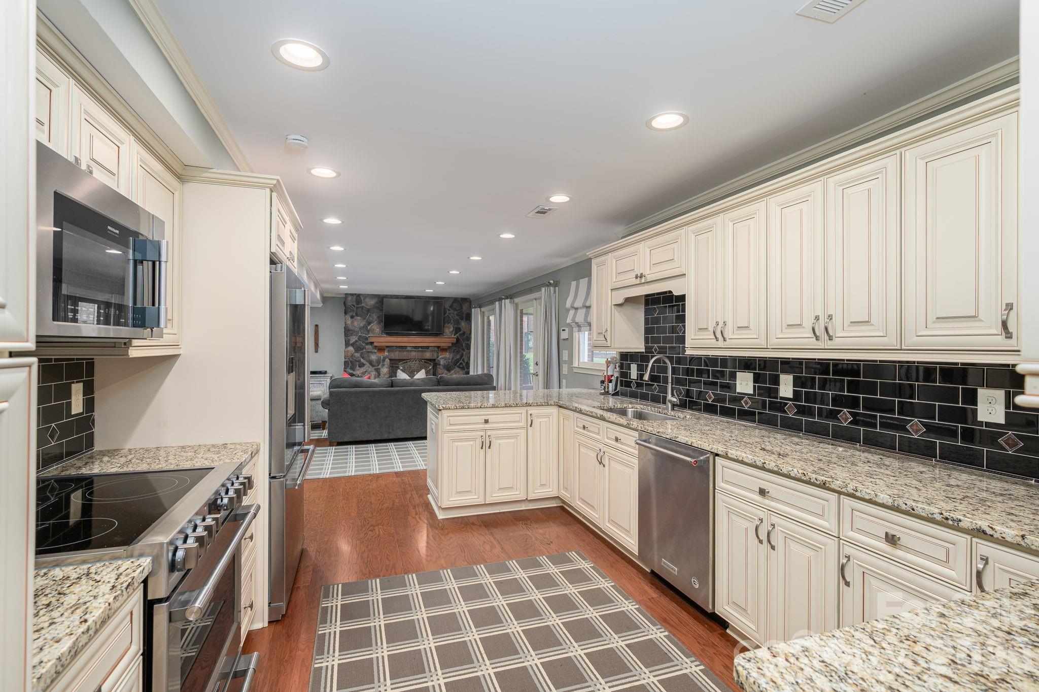 872 Armstrong Road Belmont, NC 28012 - Photo 44 of 48 a kitchen with stainless steel appliances granite countertop a stove a sink and a microwave