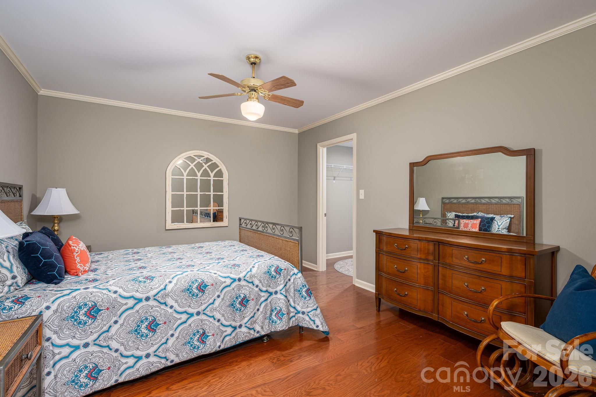 872 Armstrong Road Belmont, NC 28012 - Photo 46 of 48 a bedroom with a bed and a dresser with mirror