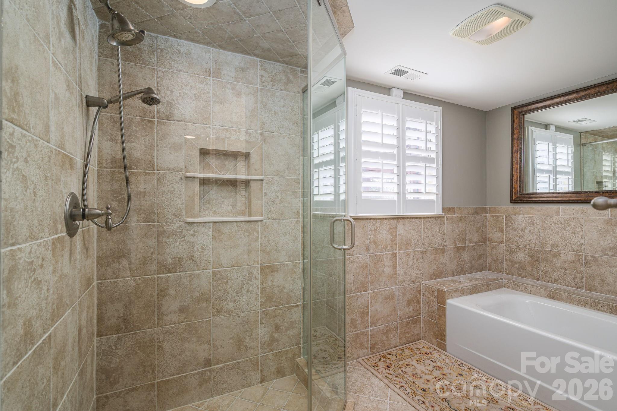 872 Armstrong Road Belmont, NC 28012 - Photo 48 of 48 a bathroom with a bathtub a window a shower and vanity