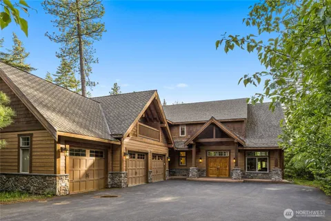 a front view of a house with a tree