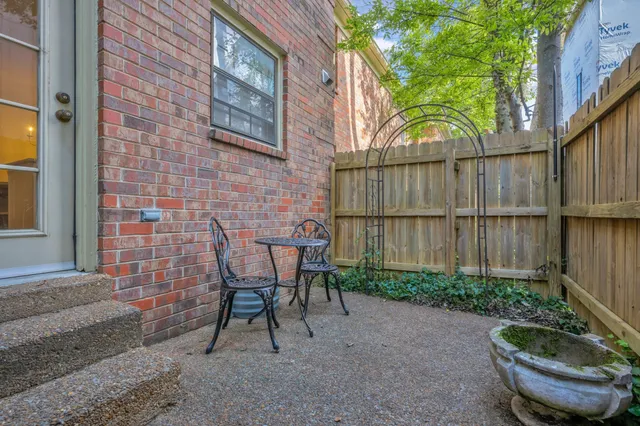 a view of a patio with table and chairs and potted plants