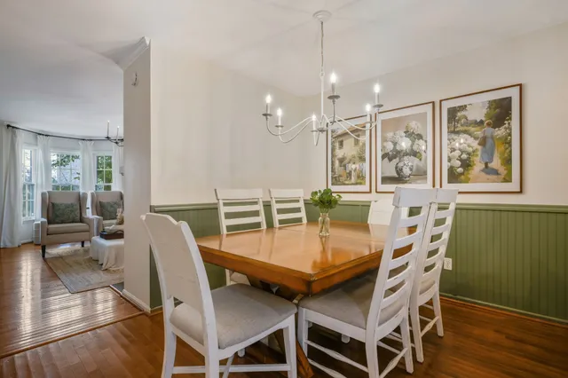 a view of a dining room with furniture wooden floor and a chandelier