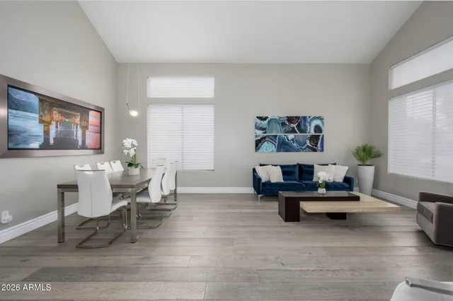a living room with furniture and paintings on the wall