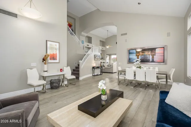 a living room with furniture and wooden floor