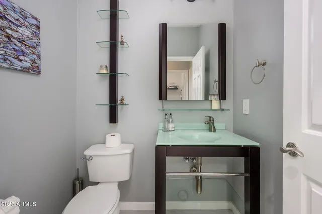 a bathroom with a toilet sink and mirror