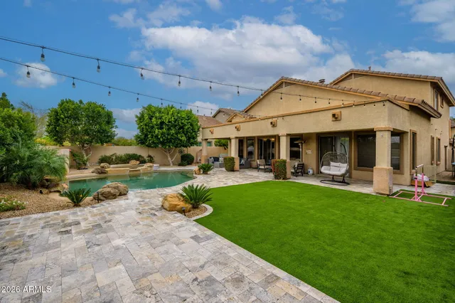 a view of a house with sitting area and garden