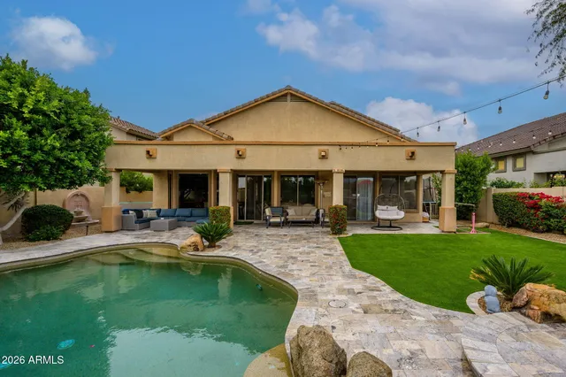 a view of a house with swimming pool and a yard