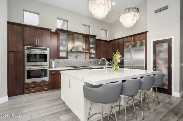 a kitchen with stainless steel appliances granite countertop a sink and cabinets