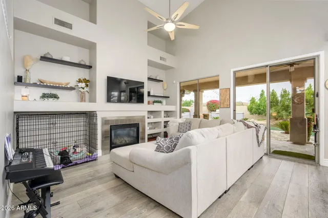 a living room with furniture a fireplace and a flat screen tv