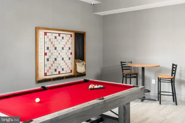 a room with pool table and a bookshelf