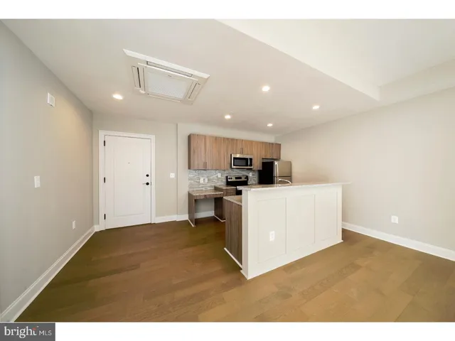 a view of kitchen with stainless steel appliances refrigerator stove microwave and stove