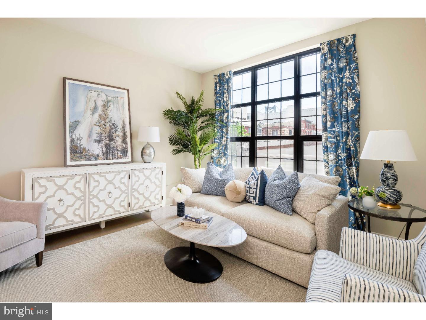 218-26 Arch Street, Unit 511 Philadelphia, PA 19106 - Photo 3 of 37 a living room with furniture and a window