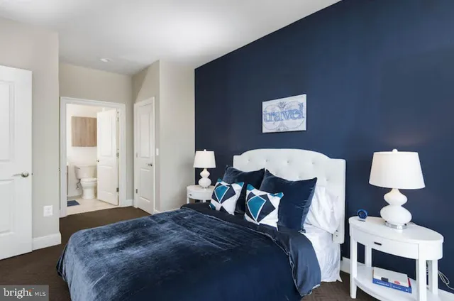 a bedroom with a bed and a lamp on table