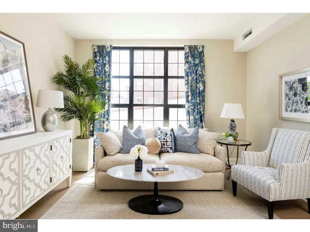 a living room with furniture and a large window