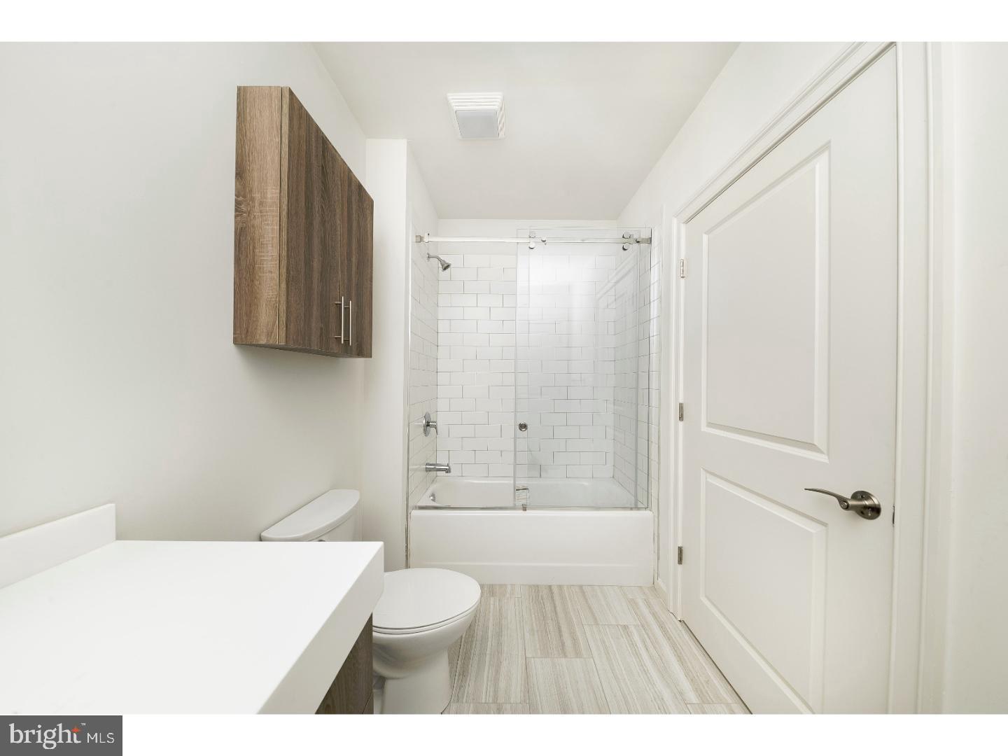 218-26 Arch Street, Unit 511 Philadelphia, PA 19106 - Photo 9 of 37 a bathroom with a shower a toilet and a sink