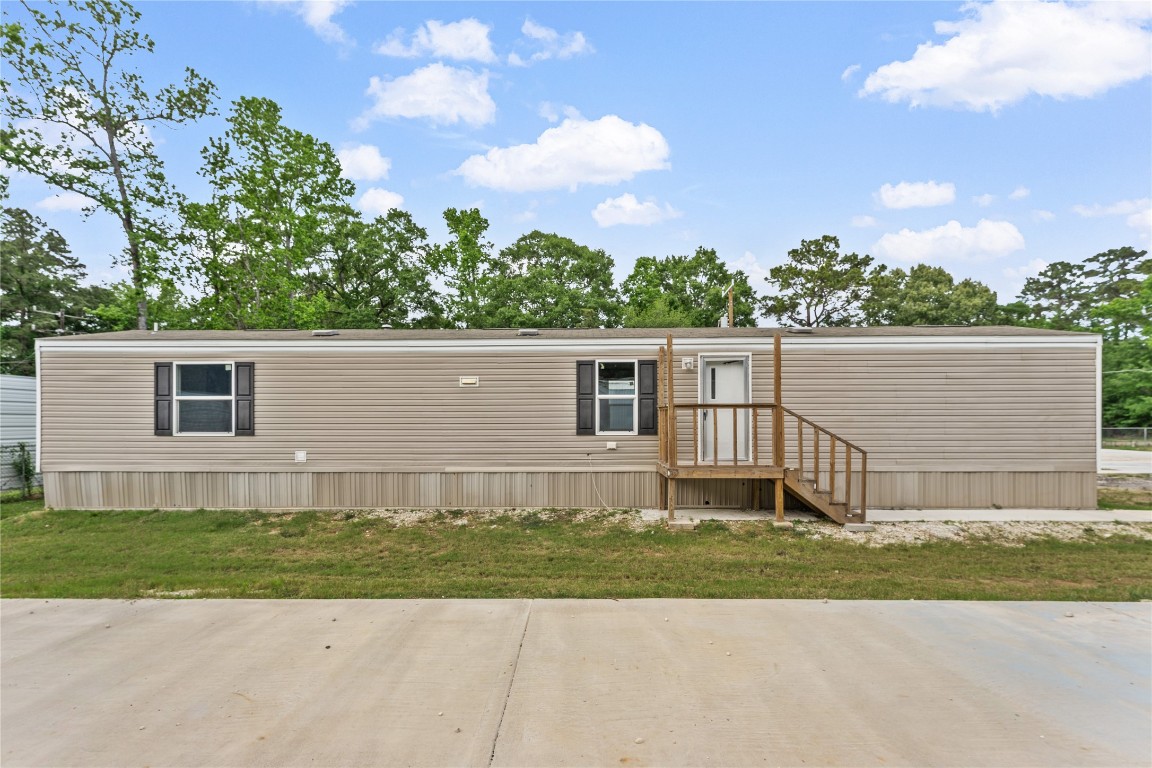 21504 Mexican John Road, Unit B New Caney, TX 77357 - Photo 13 of 13 front view of a house with a yard