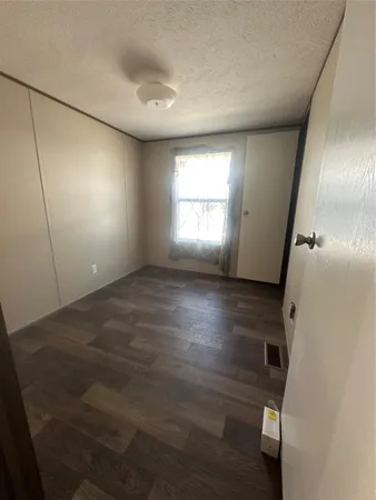 an empty room with windows and entrance