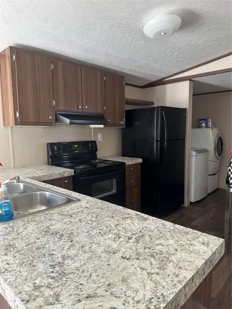 a kitchen with refrigerator and cabinets