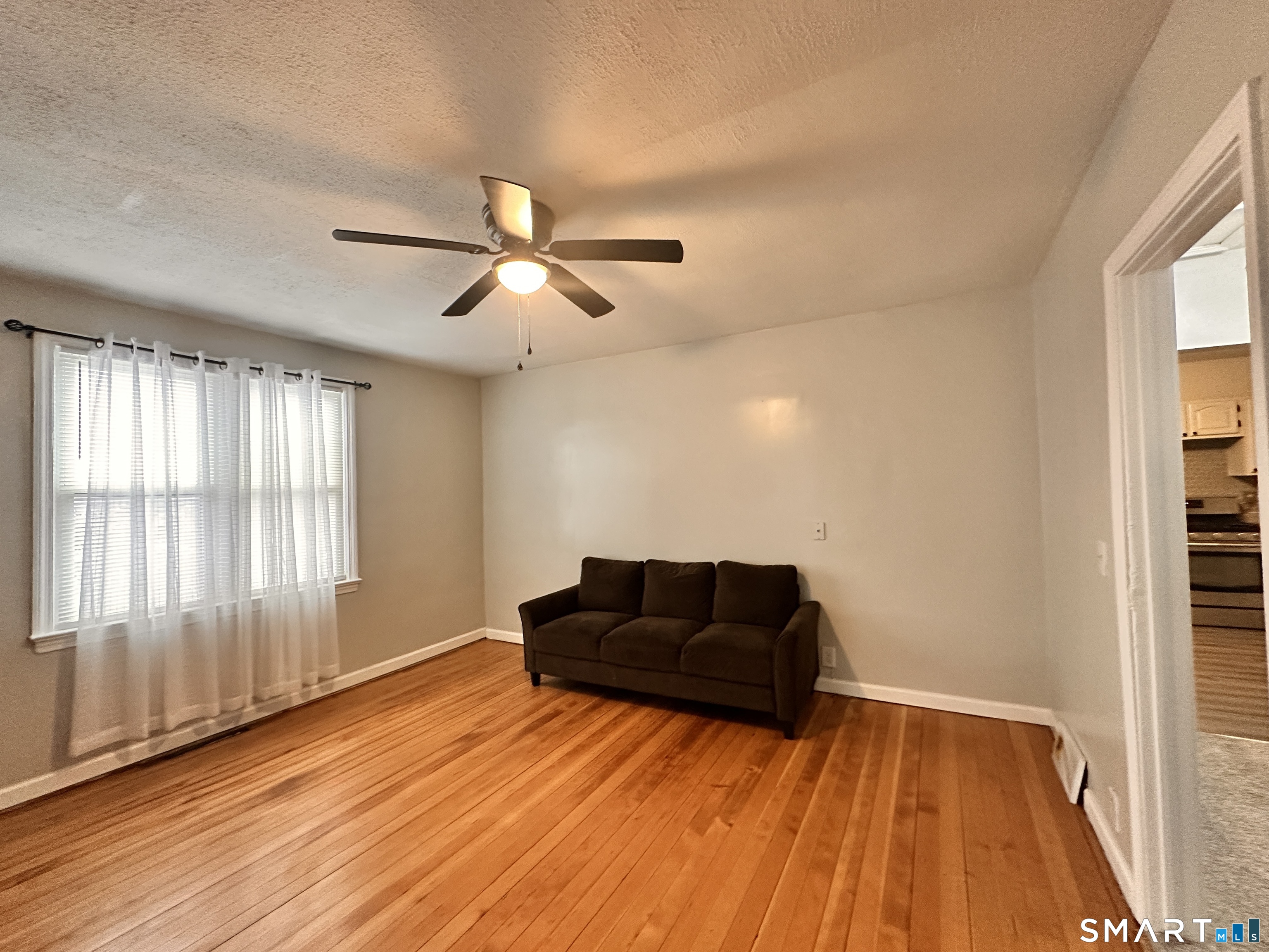 74 Mt Pleasant Street, Unit 2 Derby, CT 06418 - Photo 11 of 19 a living room with a bed furniture and a window