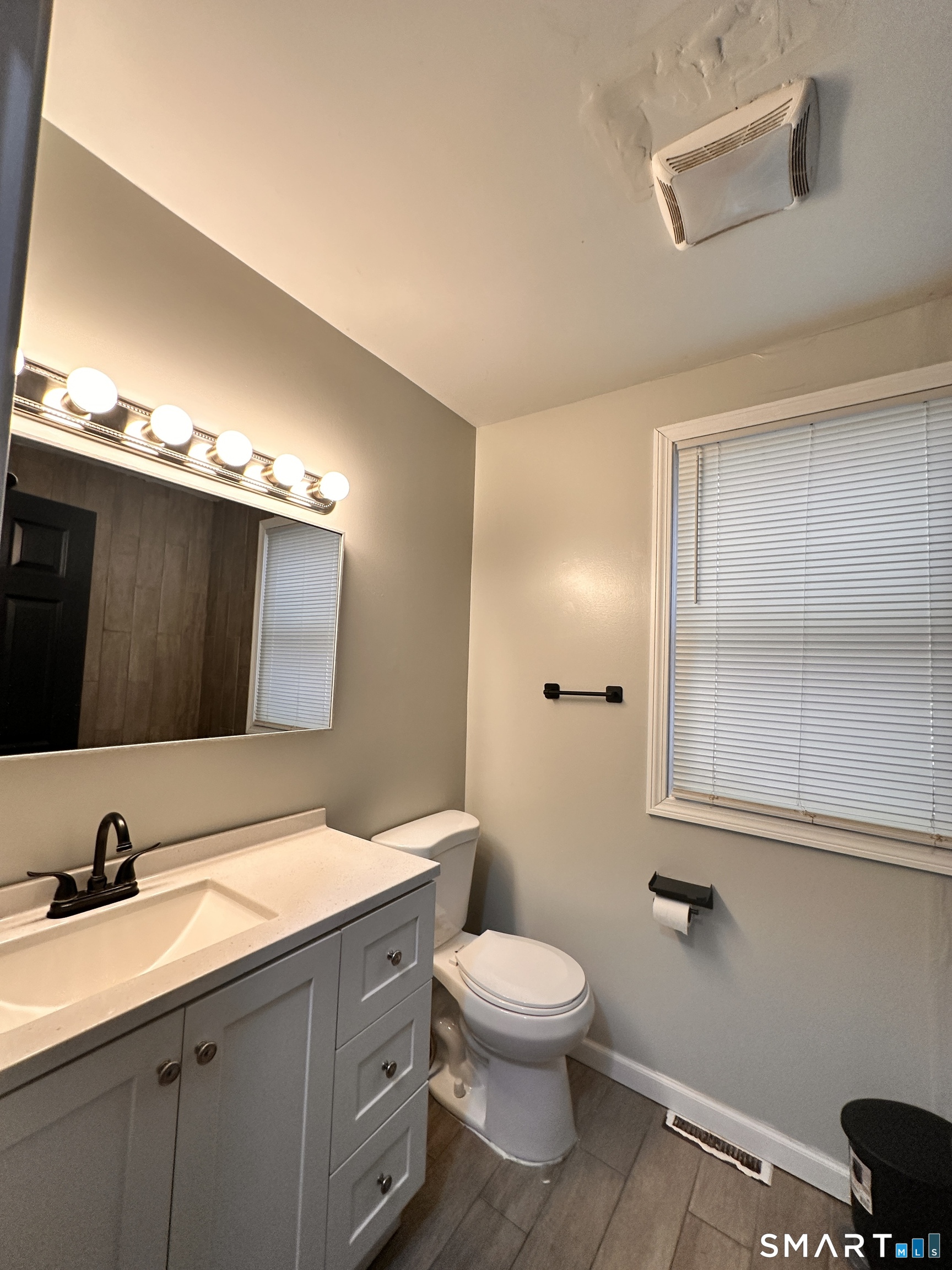 74 Mt Pleasant Street, Unit 2 Derby, CT 06418 - Photo 13 of 19 a bathroom with a toilet sink and mirror