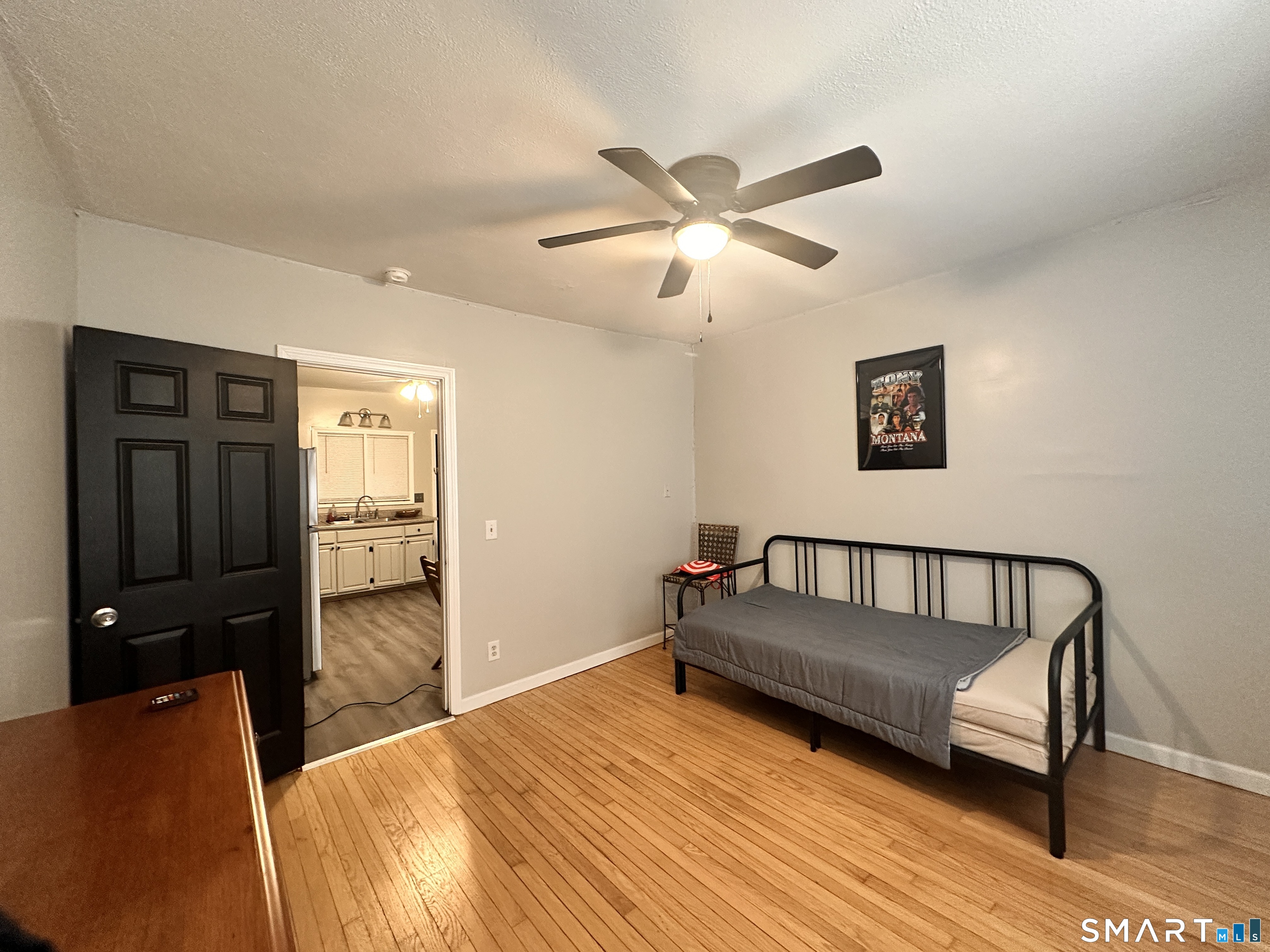 74 Mt Pleasant Street, Unit 2 Derby, CT 06418 - Photo 16 of 19 a bedroom with a bed and wooden floor