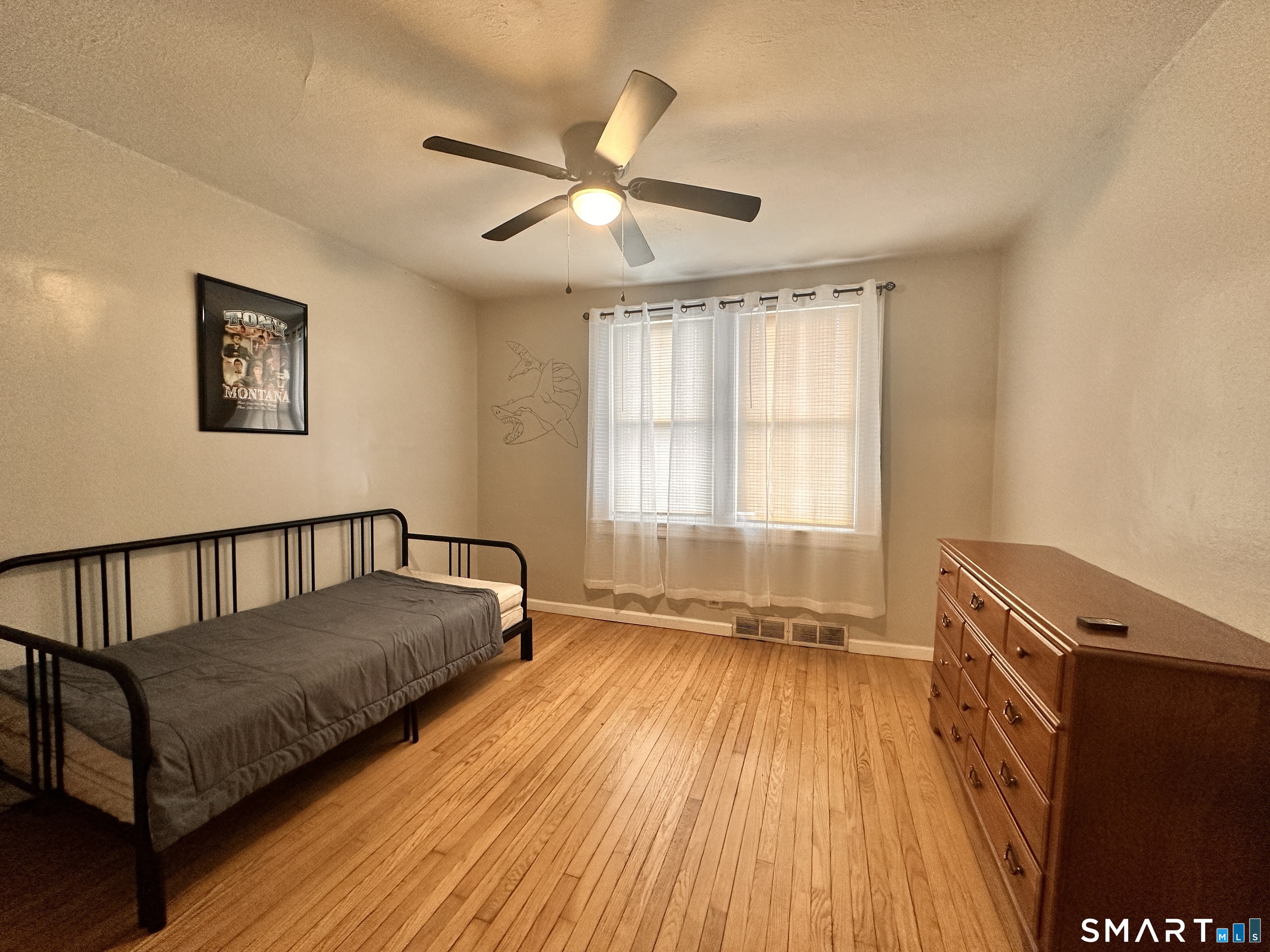 74 Mt Pleasant Street, Unit 2 Derby, CT 06418 - Photo 17 of 19 a spacious bedroom with a bed and wooden floor