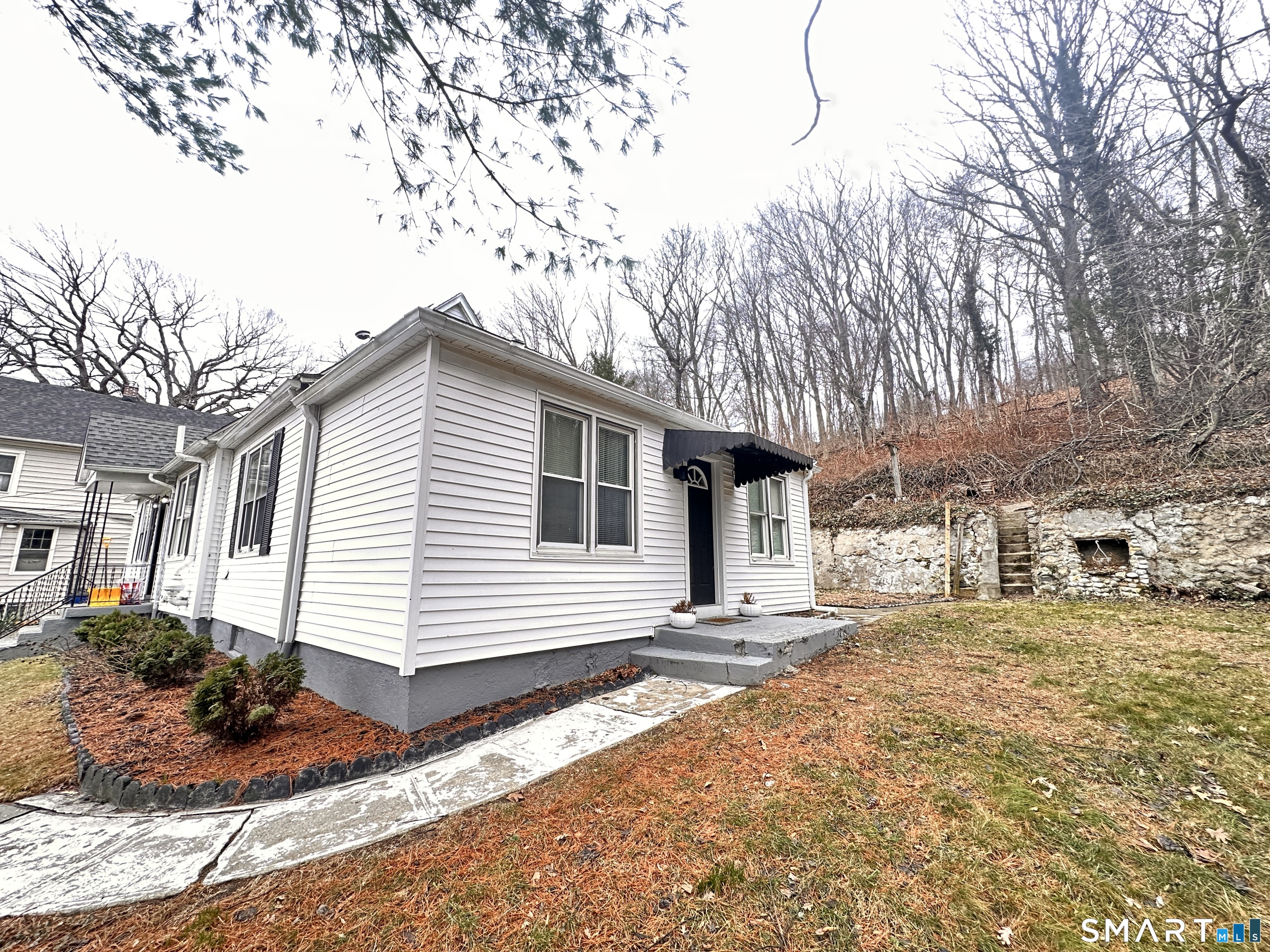 74 Mt Pleasant Street, Unit 2 Derby, CT 06418 - Photo 3 of 19 a white house with a large tree in front of it