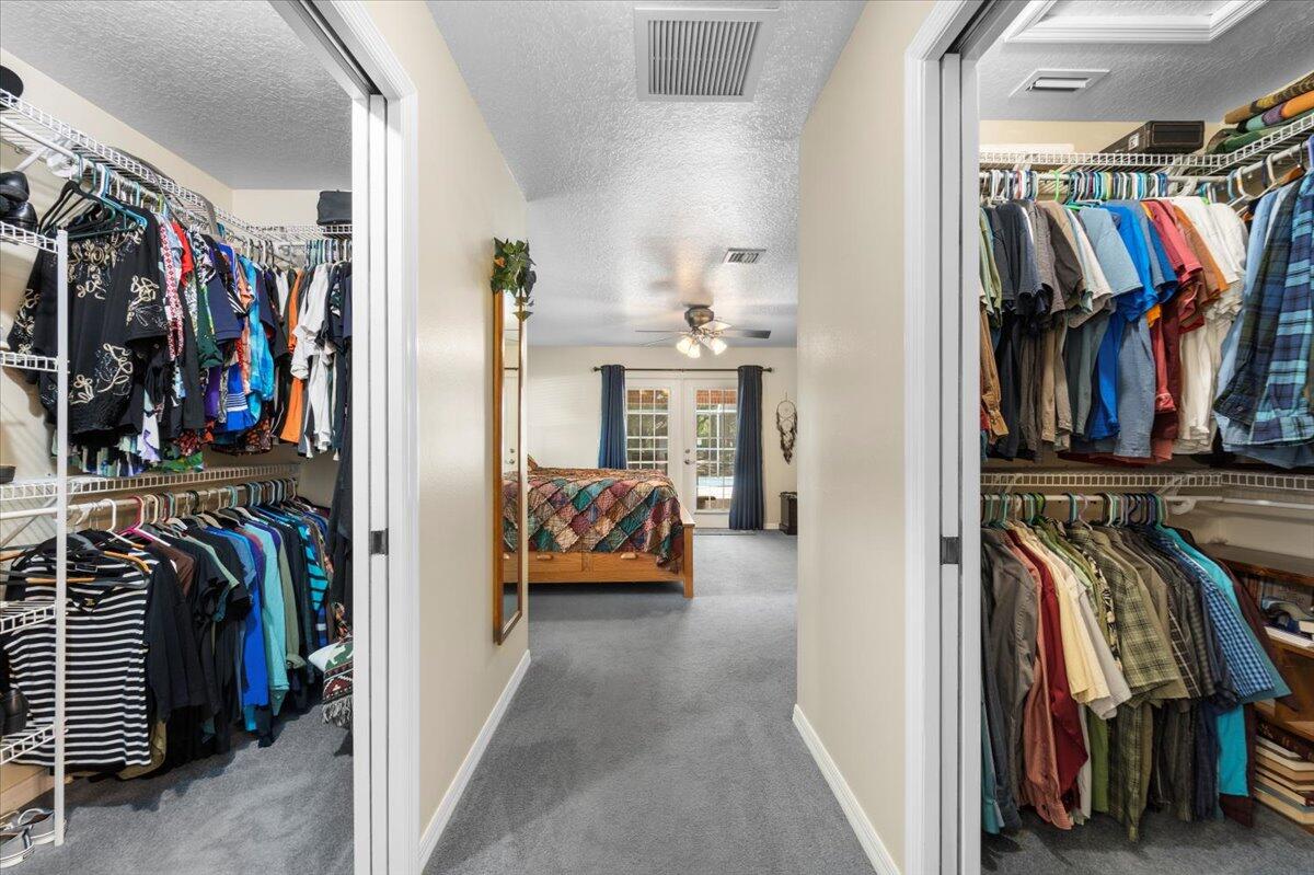 3455 Carter Road Mims, FL 32754 - Photo 16 of 38 a view of walk in closet with clothes and shoes