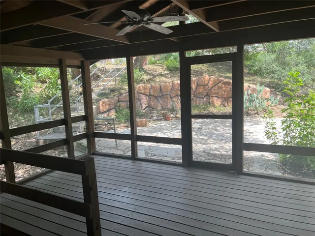 a view of hallway with stairs and wooden floor