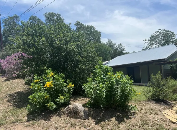a view of a house with a yard and garden