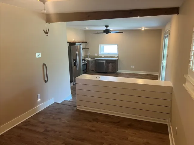 a kitchen with stainless steel appliances granite countertop a stove a refrigerator and a sink