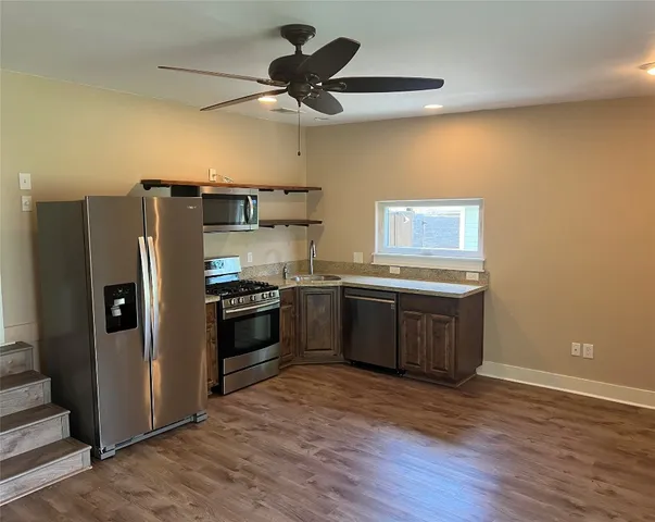 a kitchen with stainless steel appliances granite countertop a sink stove and microwave