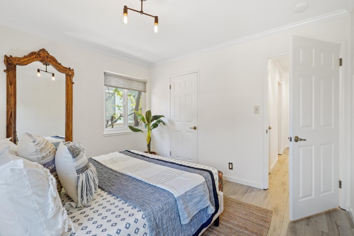 418 Dwight Road Burlingame, CA 94010 - Photo 27 of 45 a bedroom with a bed and a potted plant