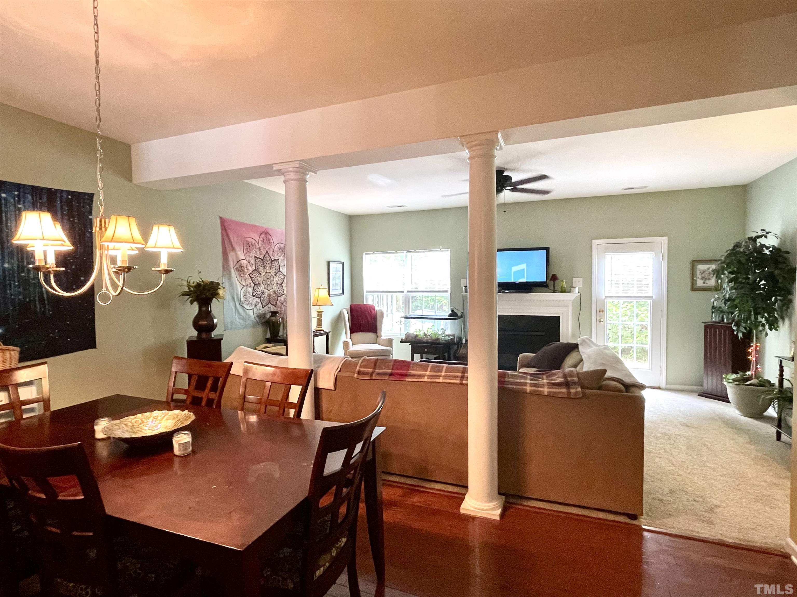 113 Graystar Road Apex, NC 27502 - Photo 8 of 24 a view of a dining room with furniture and wooden floor