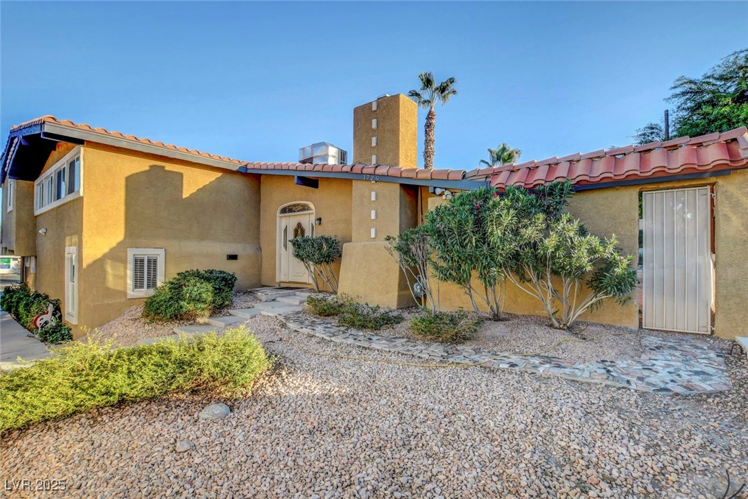 Mediterranean / spanish-style house with stucco siding and a tiled roof