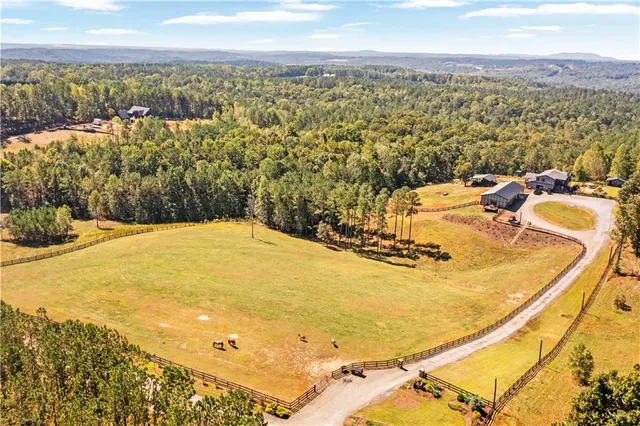 a view of a patio with a table and chairs under an umbrella