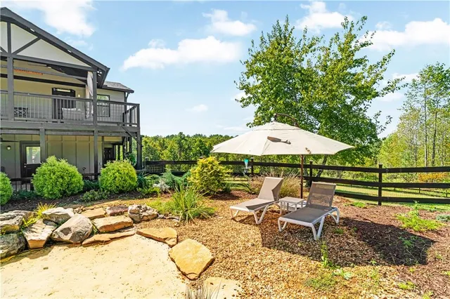 a view of a hallway with wooden floor and windows