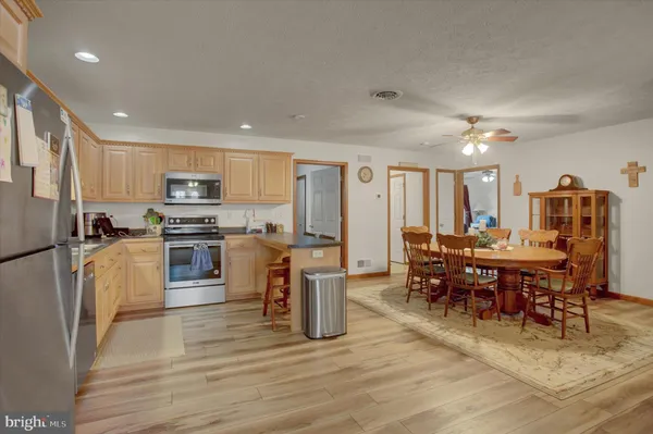 a kitchen with furniture a counter top space stainless steel appliances and cabinets
