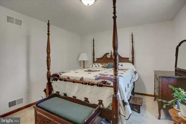 a bedroom with a bed and a table