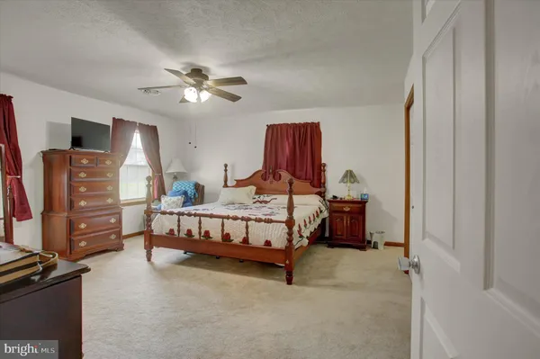 a bedroom with bed and wooden closet
