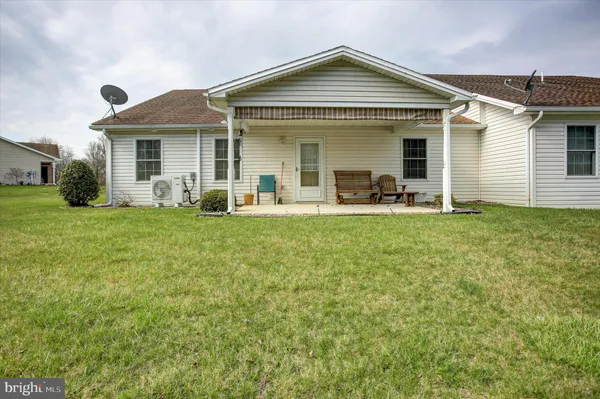 a front view of a house with a yard and porch