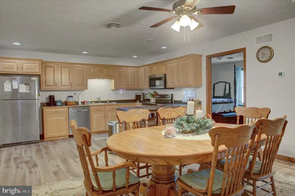 a view of kitchen with cabinets table and chairs