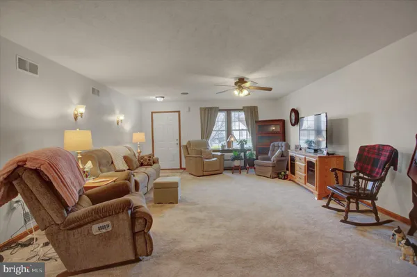 a living room with furniture and a lamp