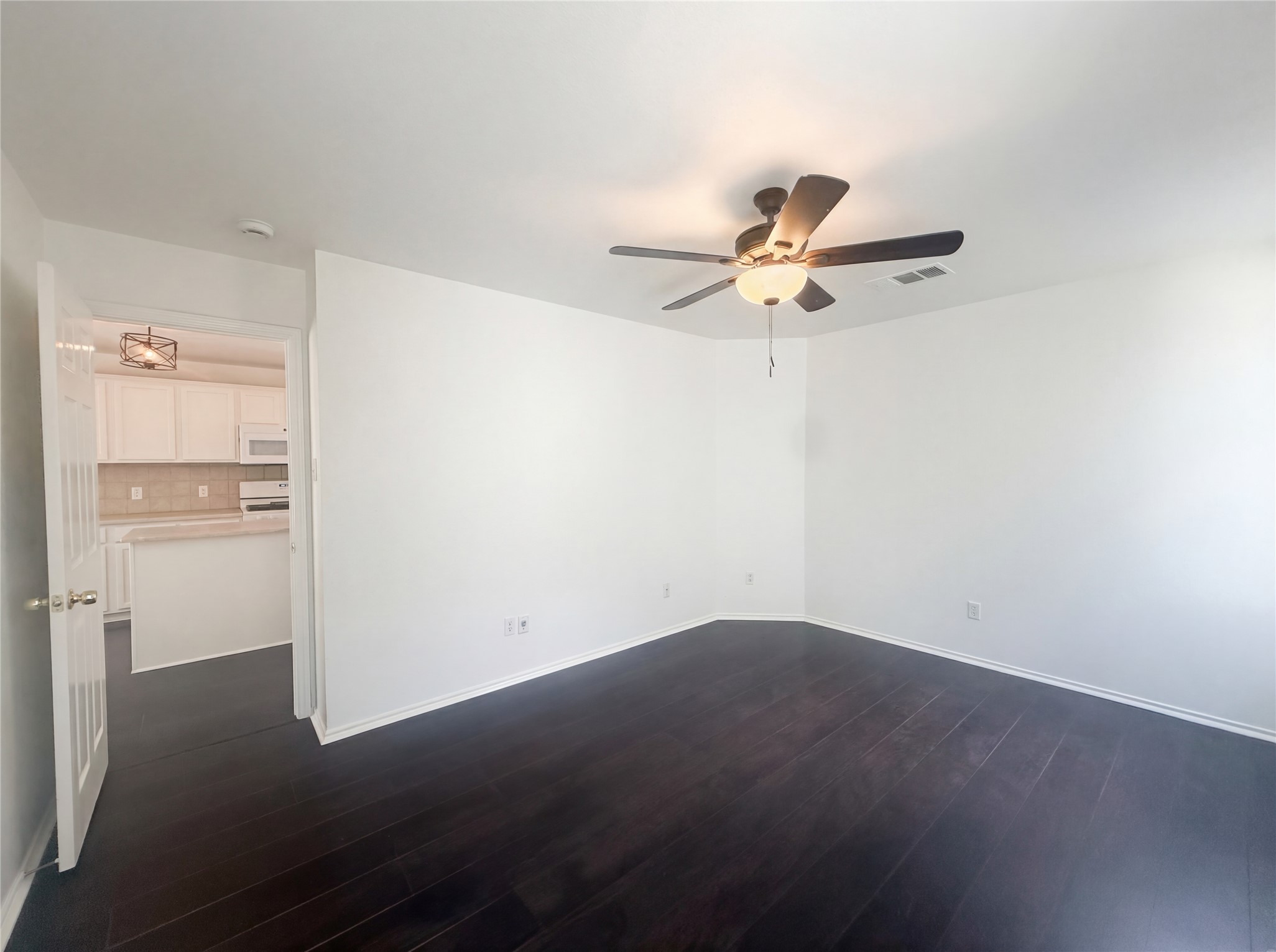 110 Strawn Kyle, TX 78640 - Photo 13 of 22 Spare room featuring dark wood-style floors and ceiling fan