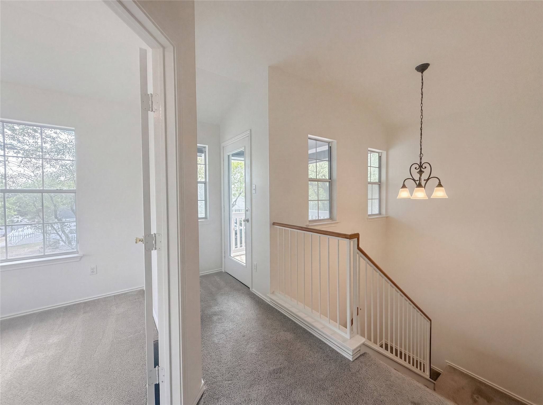 110 Strawn Kyle, TX 78640 - Photo 20 of 22 Hall with light carpet and hanging lights