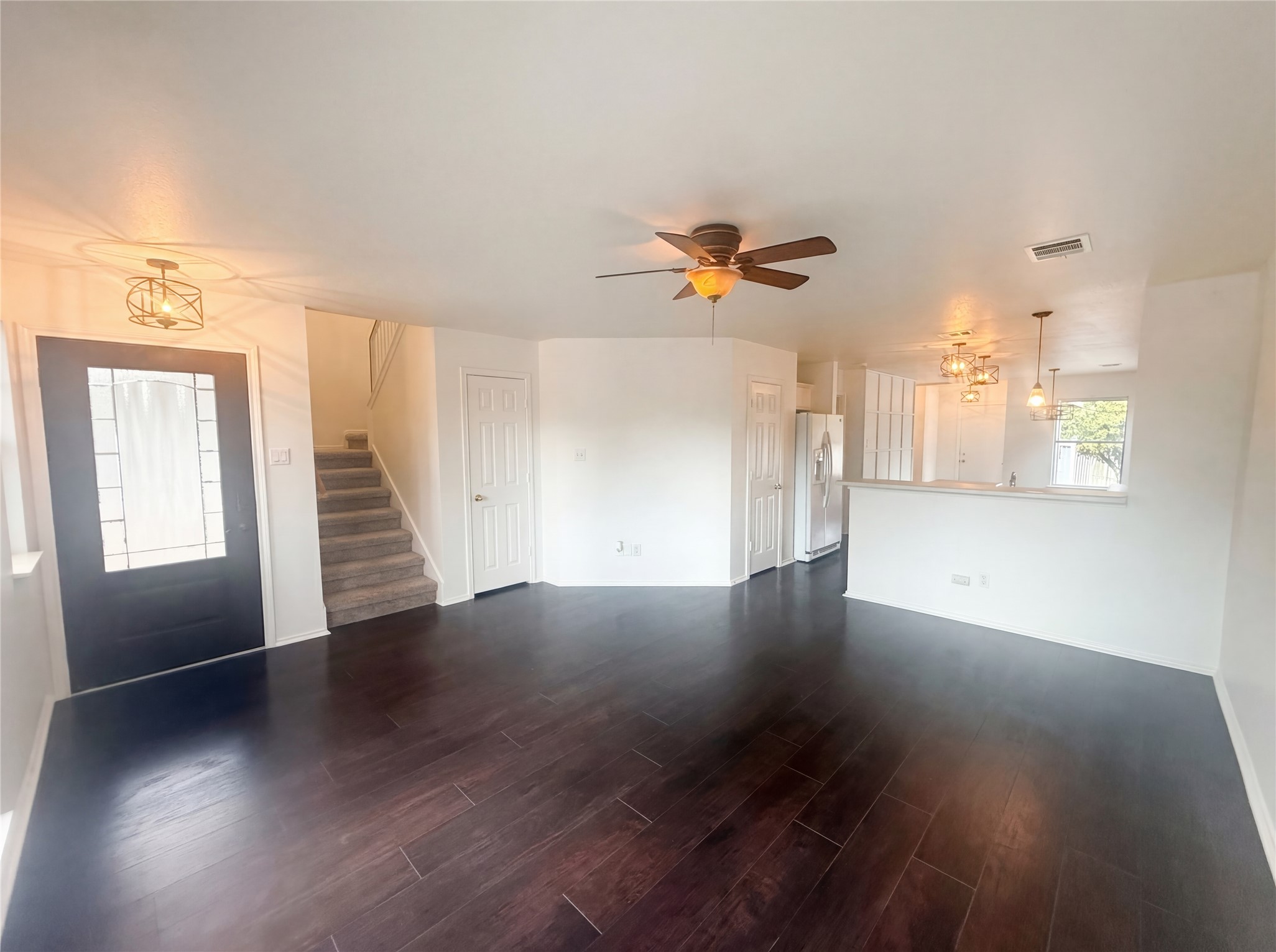 110 Strawn Kyle, TX 78640 - Photo 3 of 22 Unfurnished living room featuring dark wood-style flooring and a ceiling fan