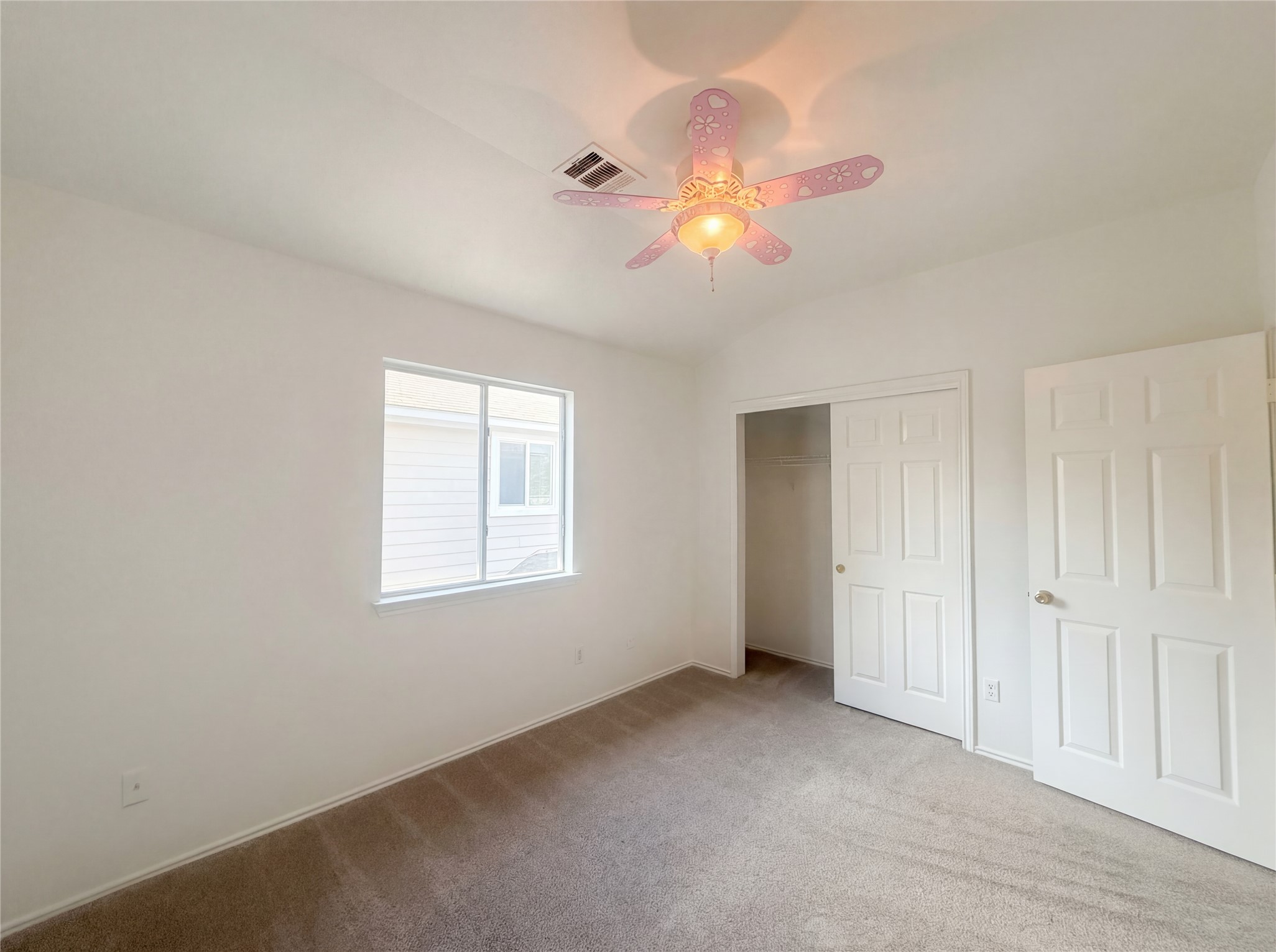 110 Strawn Kyle, TX 78640 - Photo 4 of 22 Unfurnished bedroom with carpet floors, a closet, a ceiling fan, and vaulted ceiling