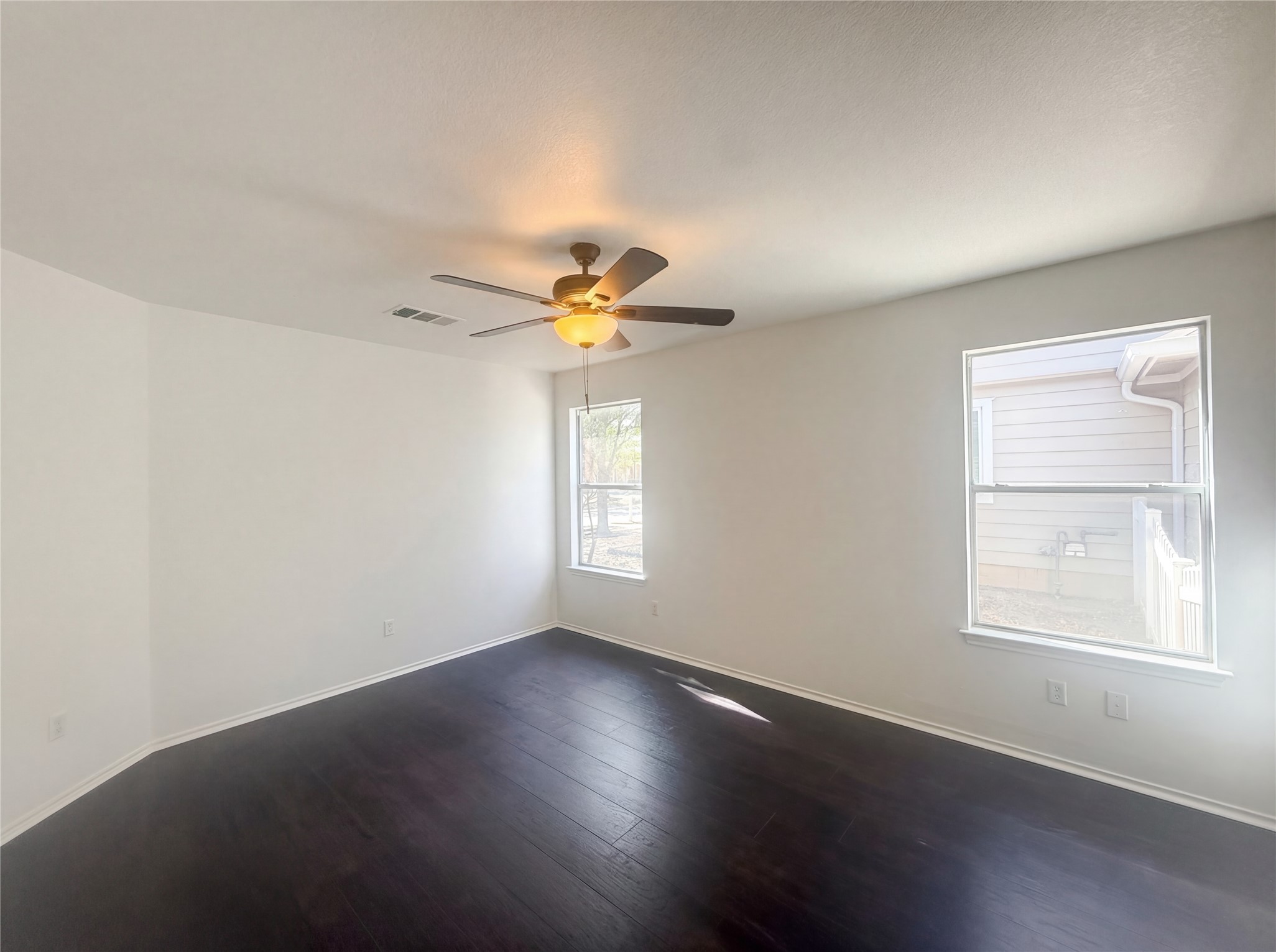 110 Strawn Kyle, TX 78640 - Photo 10 of 22 Empty room with dark wood-type flooring and ceiling fan